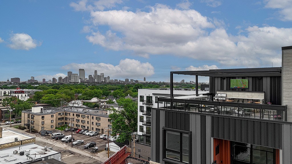A modern building with a balcony overlooking a cityscape.