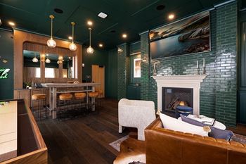 A living room with a fireplace and a painting on the wall.