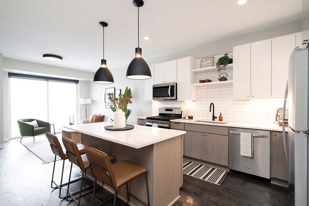 A modern kitchen with a dining table and chairs.