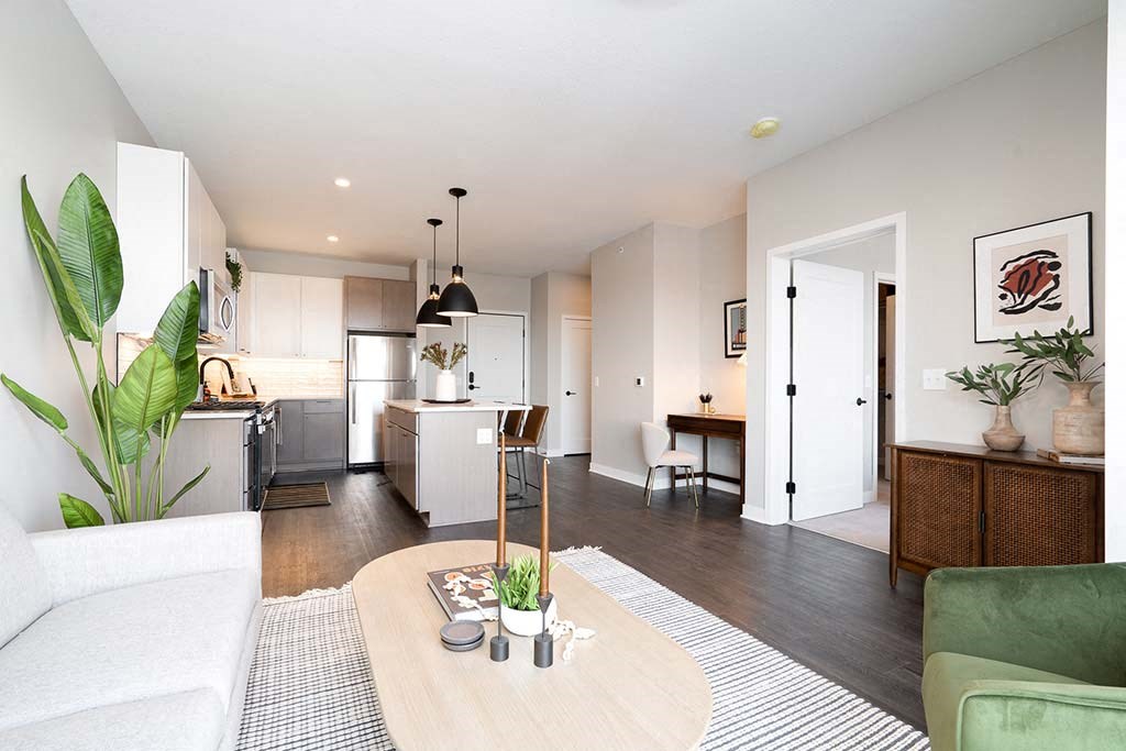 A modern living room with a white sofa and a wooden coffee table.