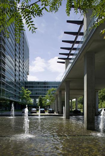 A modern building with a fountain in front of it.