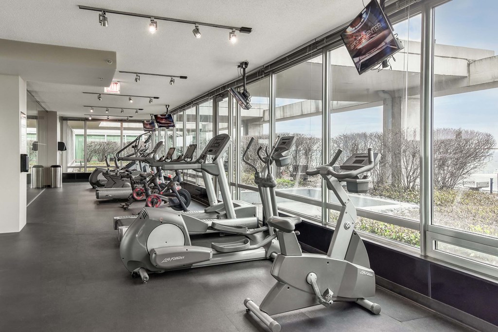 A gym with treadmills and elliptical machines.