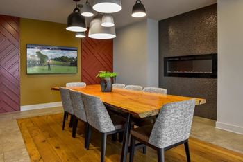 A conference room with a long table and chairs.