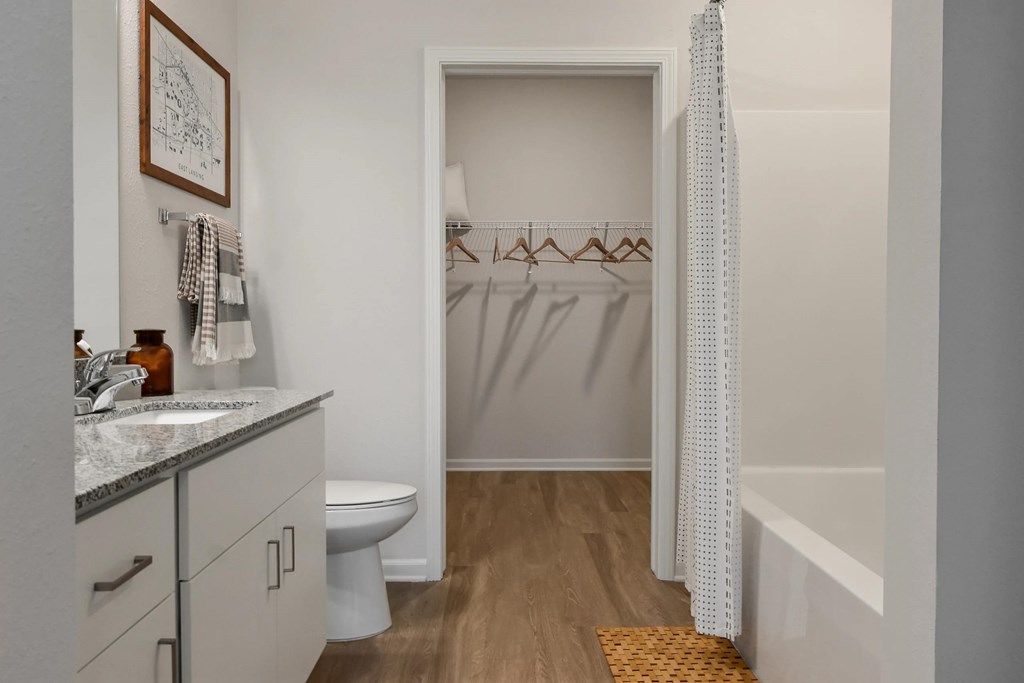A bathroom with a toilet, sink, and bathtub.