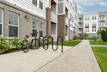 A bicycle is parked on a sidewalk in front of a brick building.