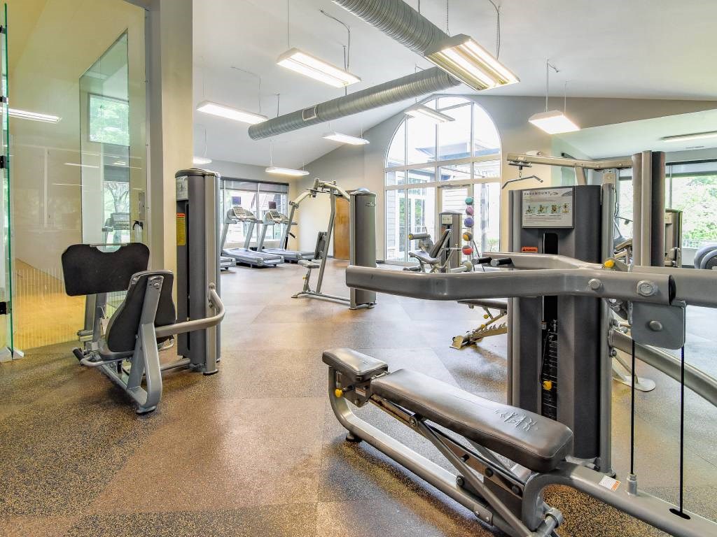 A gym with a variety of equipment including a leg press machine.