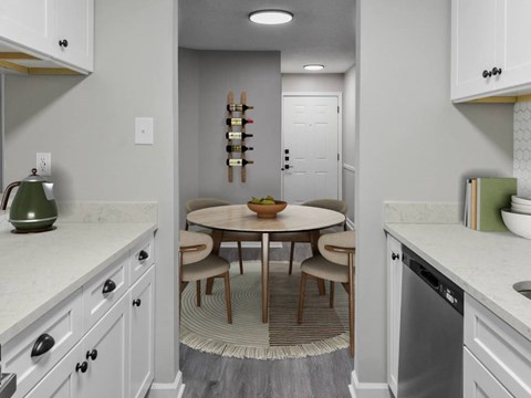 A kitchen with a round table and chairs in the middle.