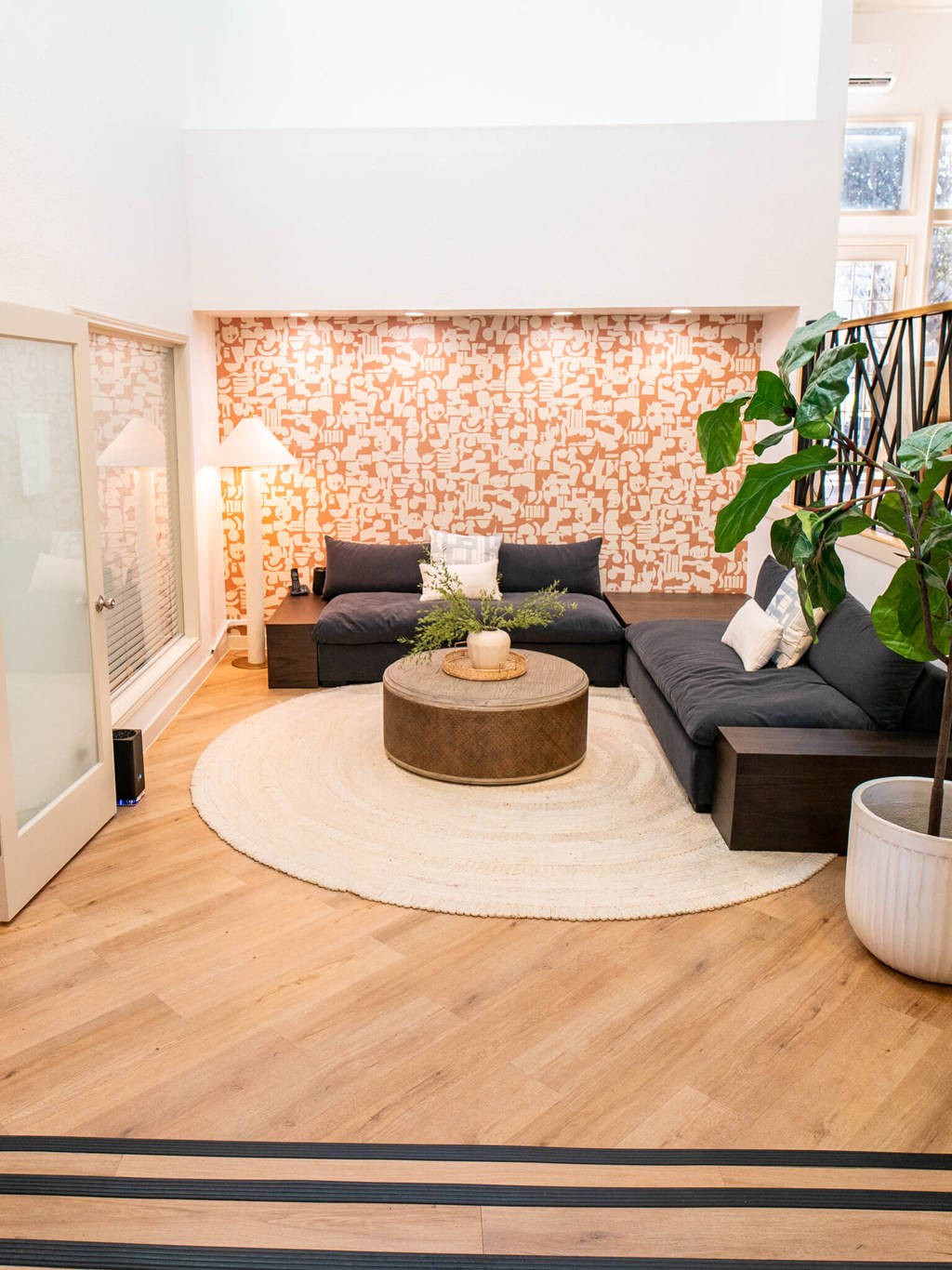 A living room with a grey couch and a wooden coffee table.