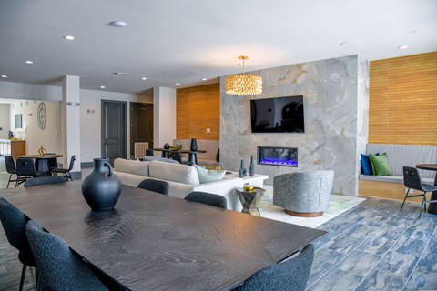 A modern dining room with a large table and chairs.