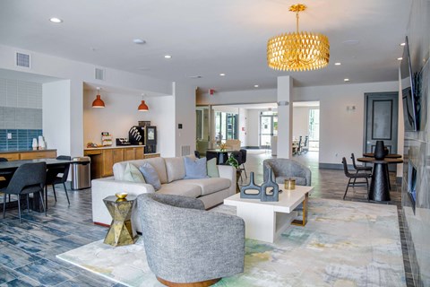 A modern living room with a grey sofa and a grey armchair.