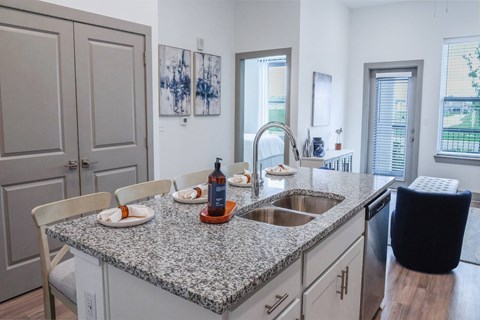 A kitchen with granite countertops and a sink.