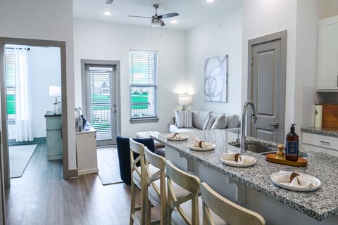 A kitchen with a table set for four.