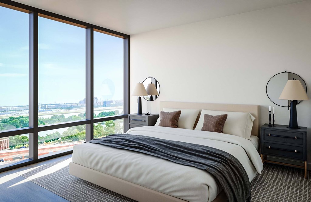 A bedroom with a large bed and a view of the city.