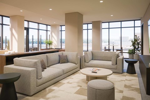 A spacious waiting area with couches, tables, and a view of the outside.