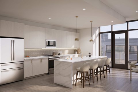 A modern kitchen with a white marble island and stainless steel appliances.