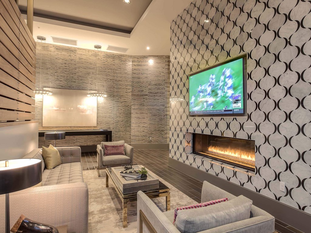 A modern living room with a television and a fireplace.