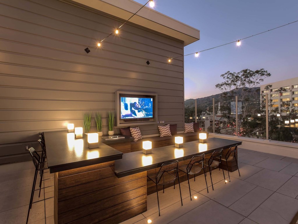 A patio with a bar and chairs is set up for an evening of relaxation.at The Adeline, California, 91203