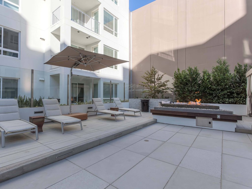 A patio with a fire pit and lounge chairs.at The Adeline, Glendale, CA 91203