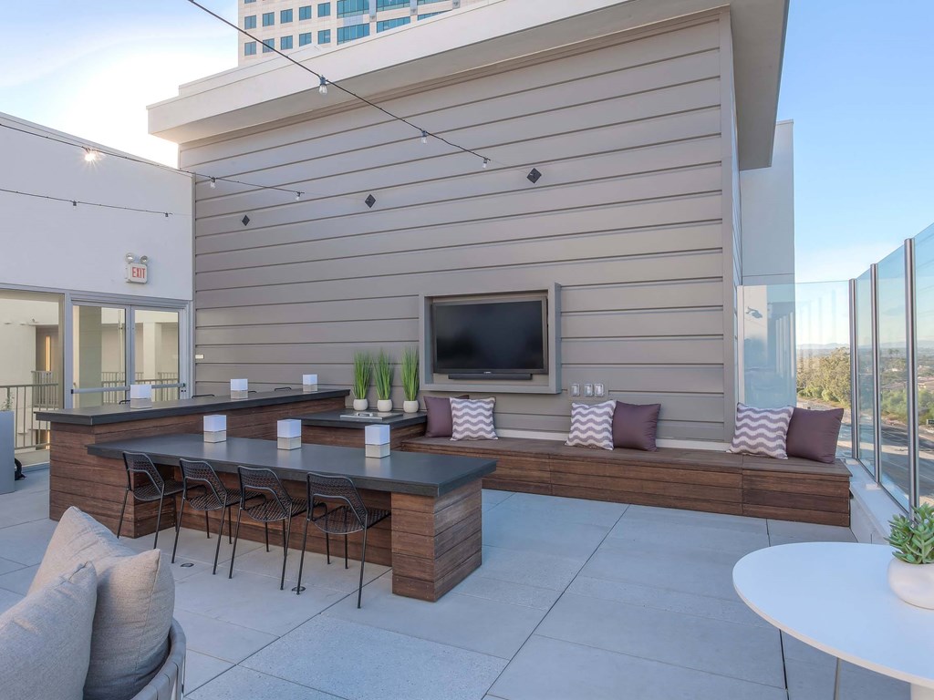 A modern outdoor patio with a bar and seating area.at The Adeline, Glendale