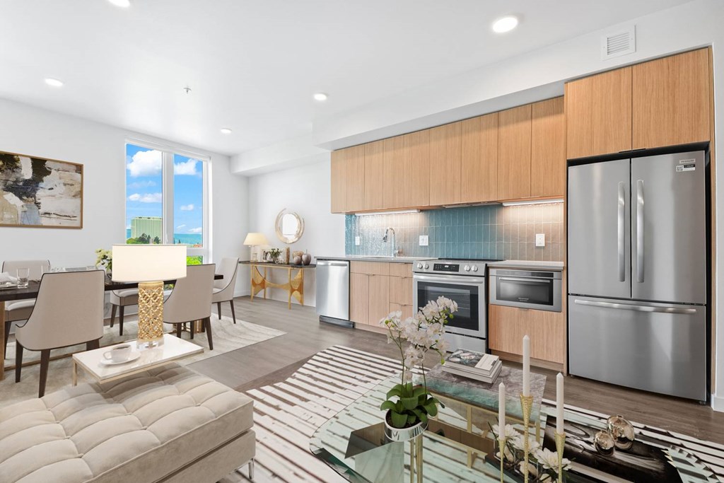 A modern kitchen with a dining table and chairs.