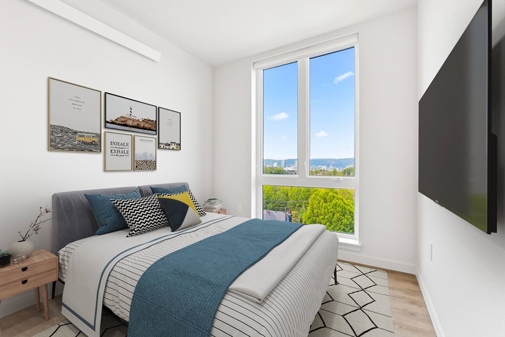 A bedroom with a large bed and a view of the city.