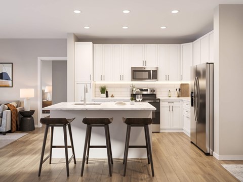 A modern kitchen with white cabinets and a center island.
