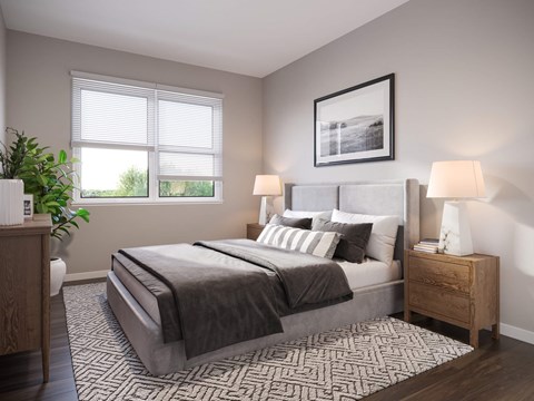 A bedroom with a large bed, two lamps, and a potted plant.
