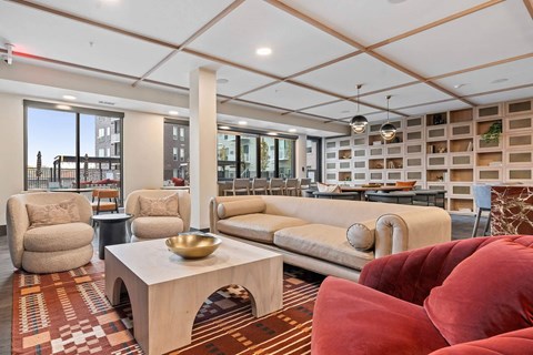 A living room with a red couch and a wooden coffee table.