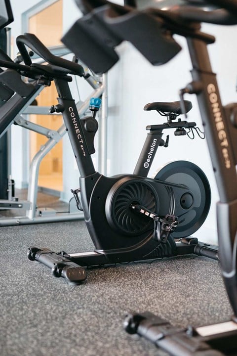 A stationary exercise bike is on the floor.
