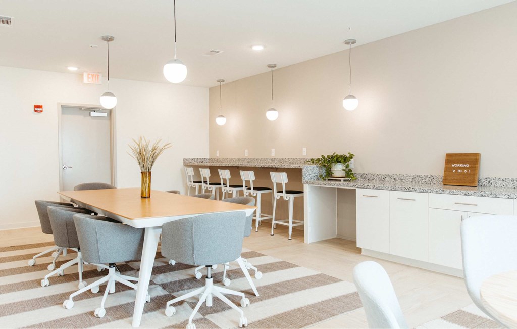 A conference room with a table and chairs.