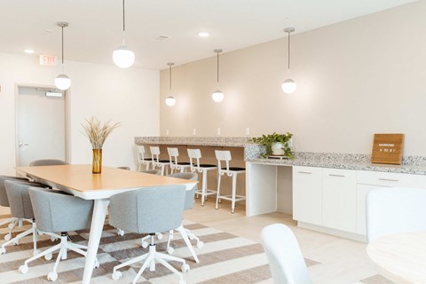 A conference room with a long table and chairs.