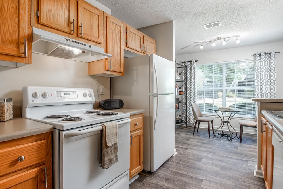 Kitchen with view of the dining area at Monterey Village apartments for rent in Jonesboro, Georgia.