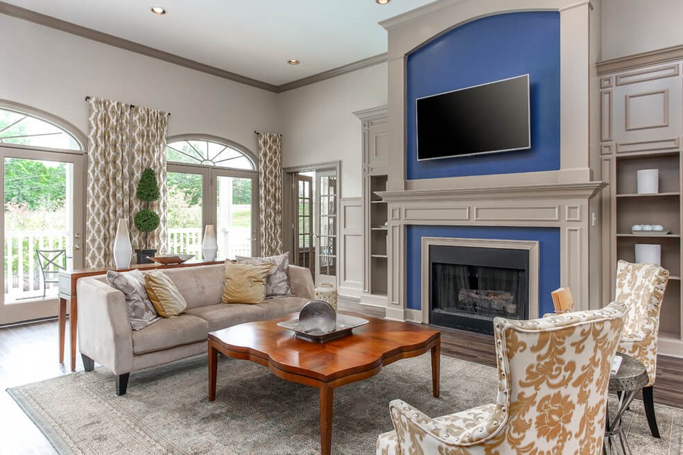 Resident lounge with fireplace and TV at Monterey Village apartments for rent in Jonesboro, GA.