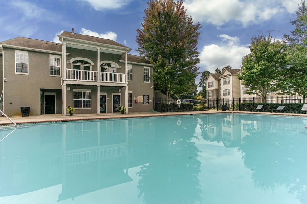 Resort-style pool with backdrop of Monterey Village apartments for rent in Jonesboro, Georgia.