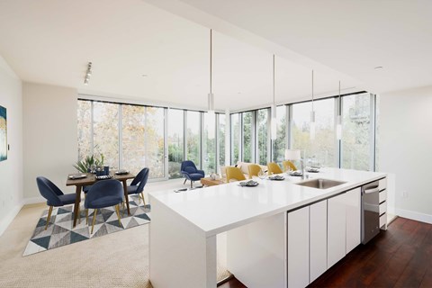 A modern kitchen with a dining table and chairs.