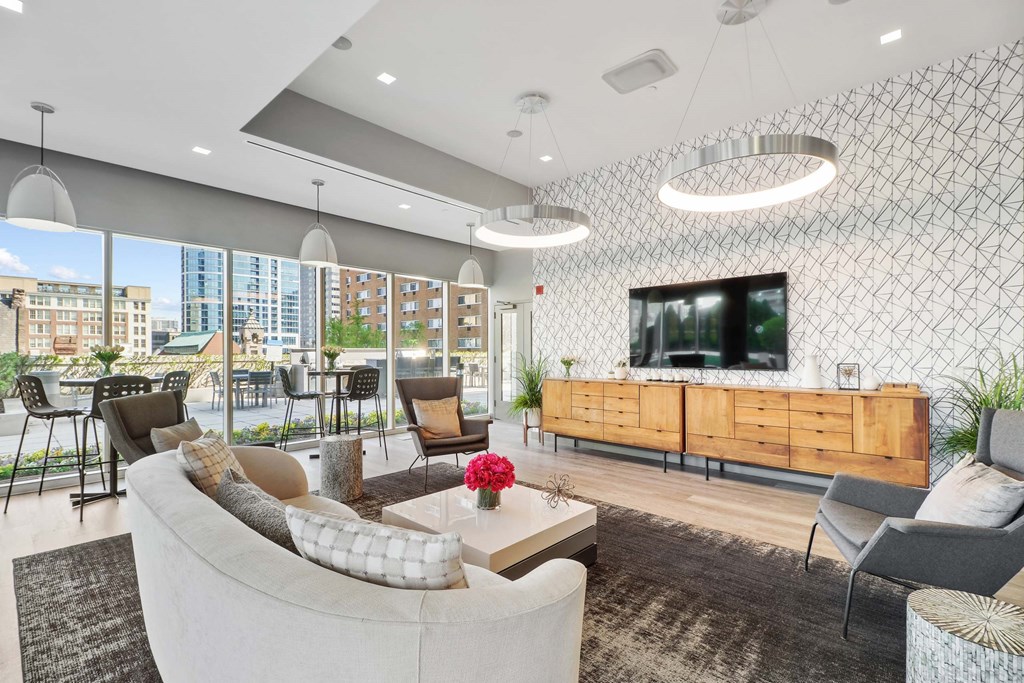 A modern living room with a large window overlooking the city.