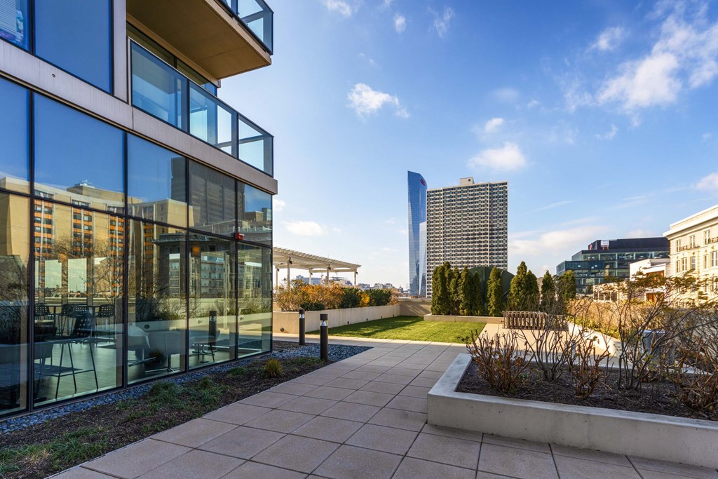 A modern building with glass windows and a clear blue sky in the background.