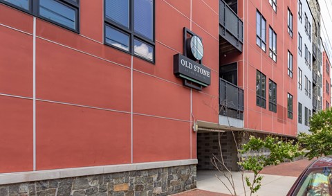 A red building with a sign that says Old Stone.