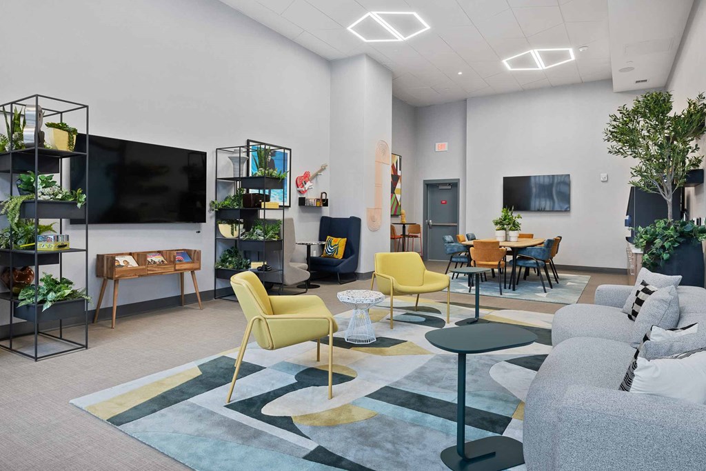 A modern living room with a yellow chair and a grey couch.