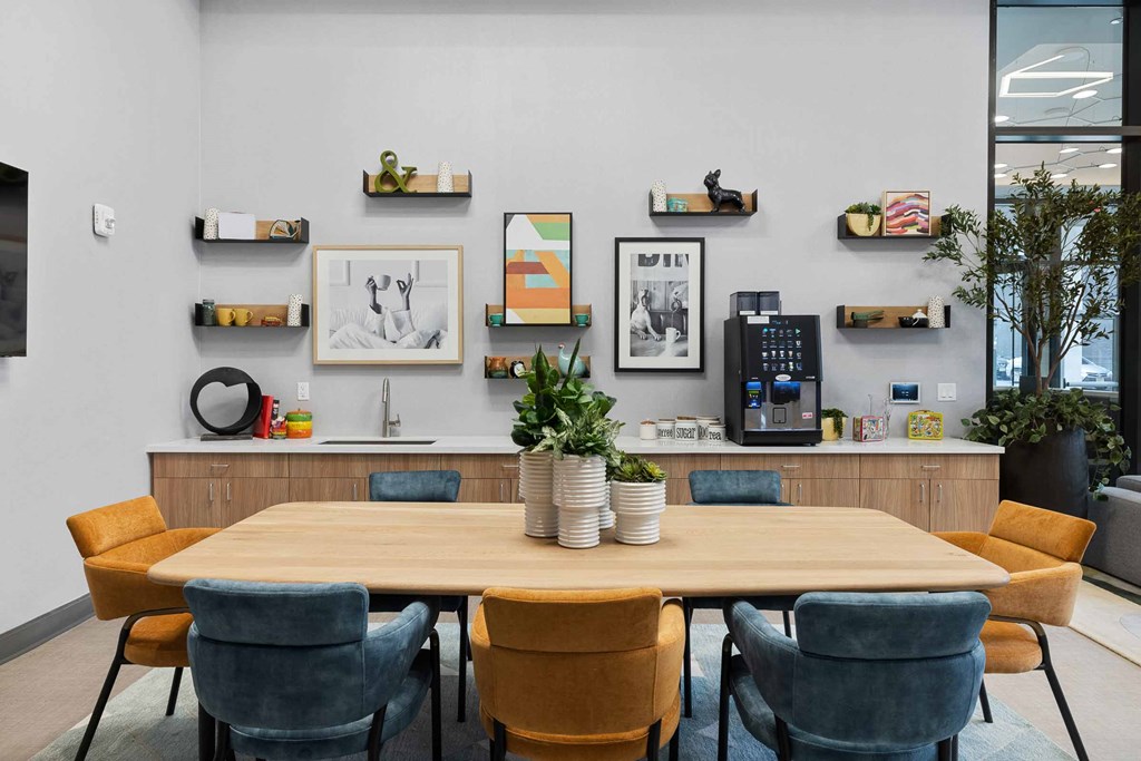 A conference room with a long table surrounded by chairs.