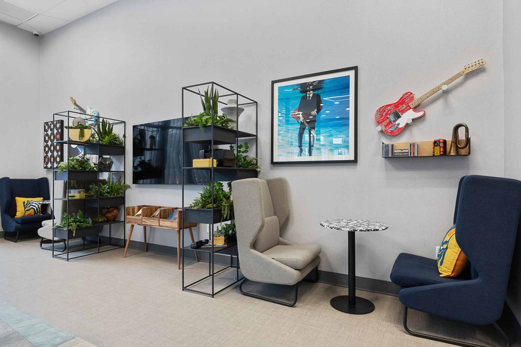 A room with a guitar and a chair.