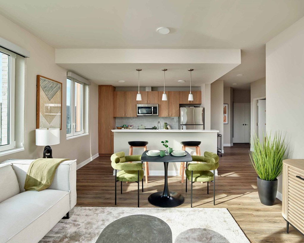 A modern kitchen with a dining table set for four.