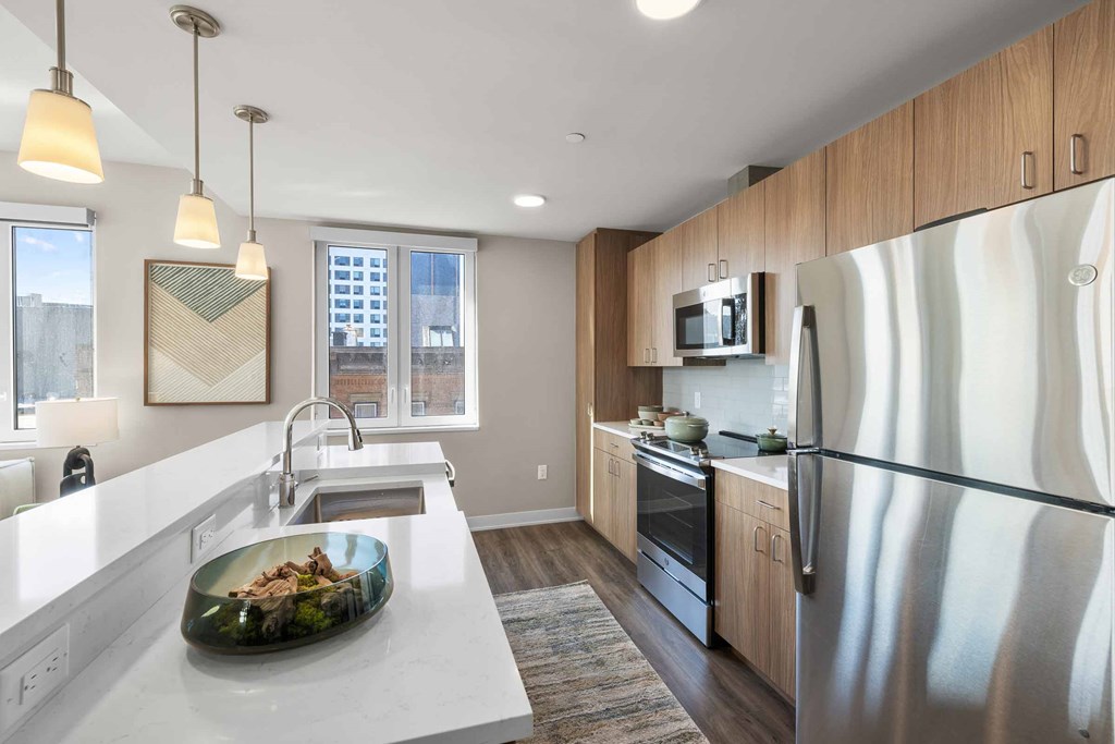 A modern kitchen with a large island and stainless steel appliances.
