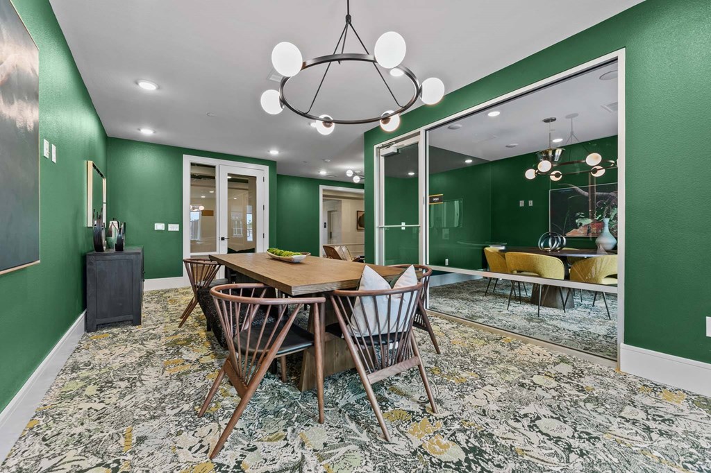 A dining room with a wooden table and chairs.