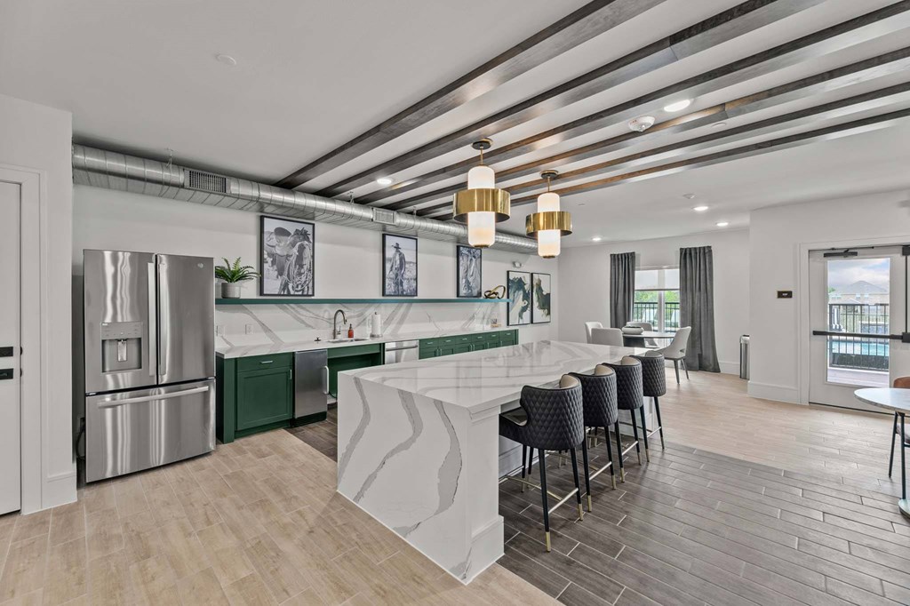 A modern kitchen with a white island and stainless steel appliances.