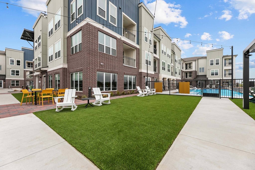 A large building with a pool in the backyard.