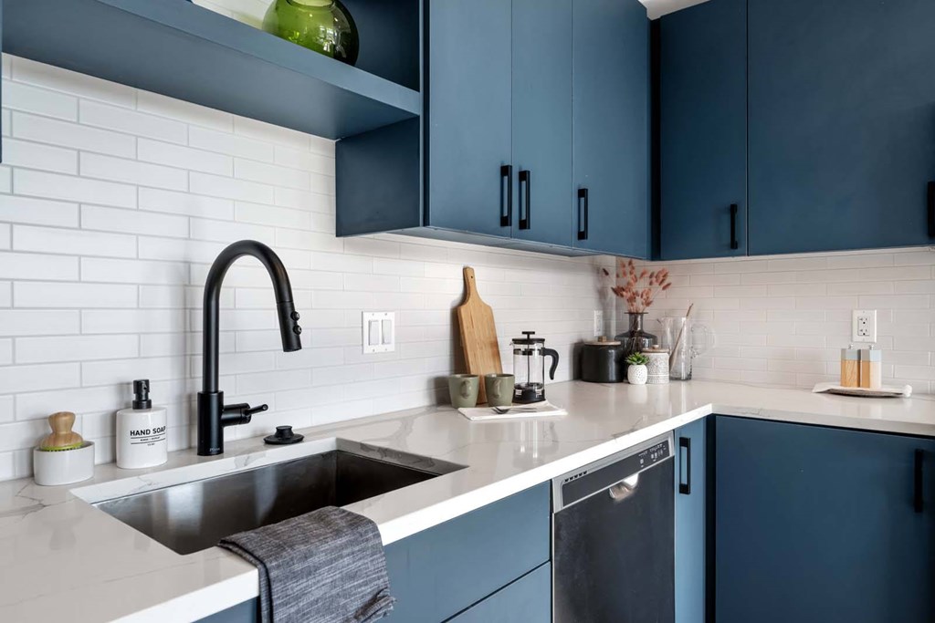 A kitchen with a sink and a dishwasher.