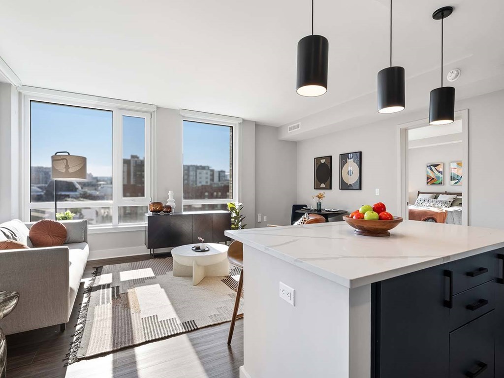 A modern kitchen with a large island and a view of the city.