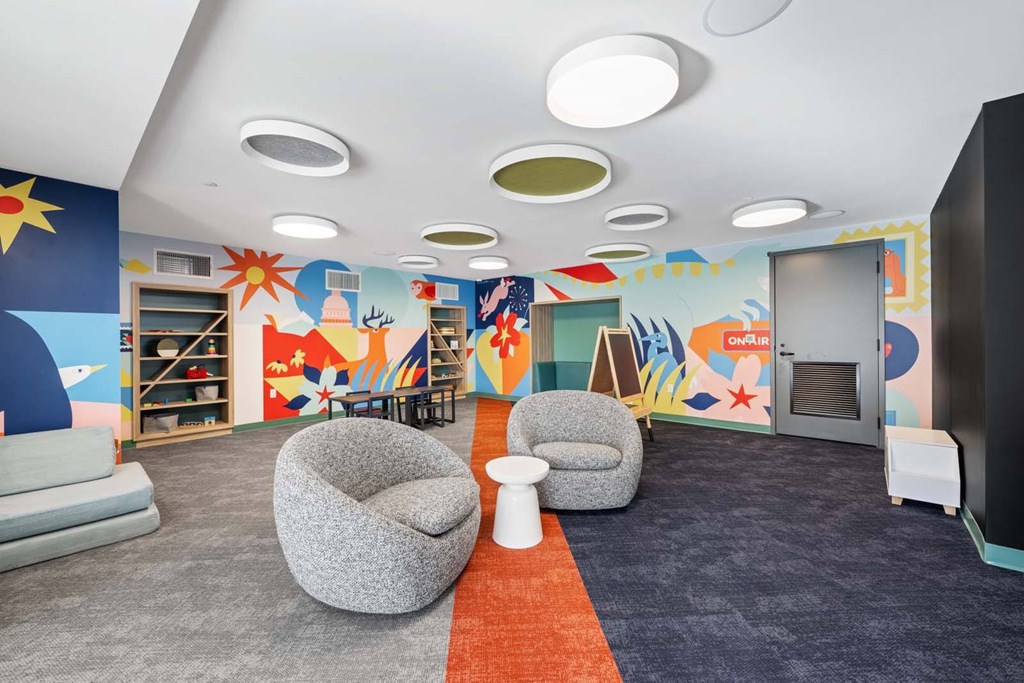 A room with a blue wall and a red carpet.