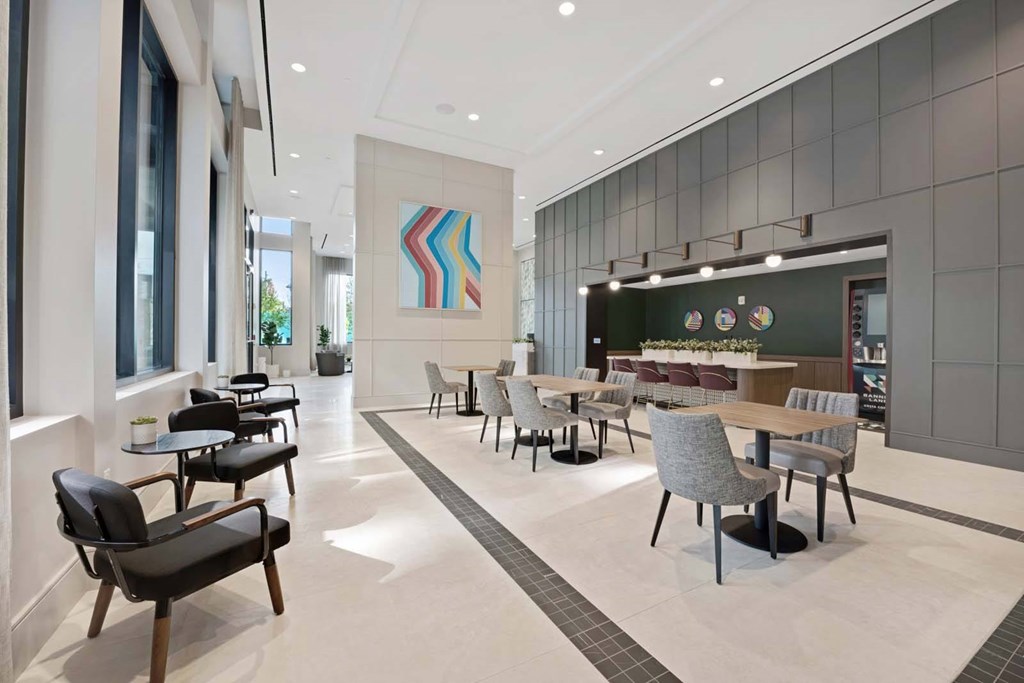 A modern dining area with a long table and chairs.